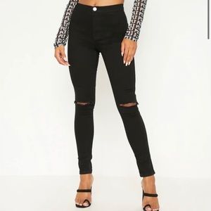 Black skinny jeans with slits at knees